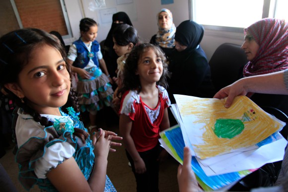 By DFID - UK Department for International Development [CC BY 2.0 (http://creativecommons.org/licenses/by/2.0)], via Wikimedia Commons" href="https://commons.wikimedia.org/wiki/File%3ARefugee_children_from_Syria_at_a_clinic_in_Ramtha%2C_northern_Jordan_(9613477263).jpg"><img width="512" alt="Refugee children from Syria at a clinic in Ramtha, northern Jordan (9613477263)